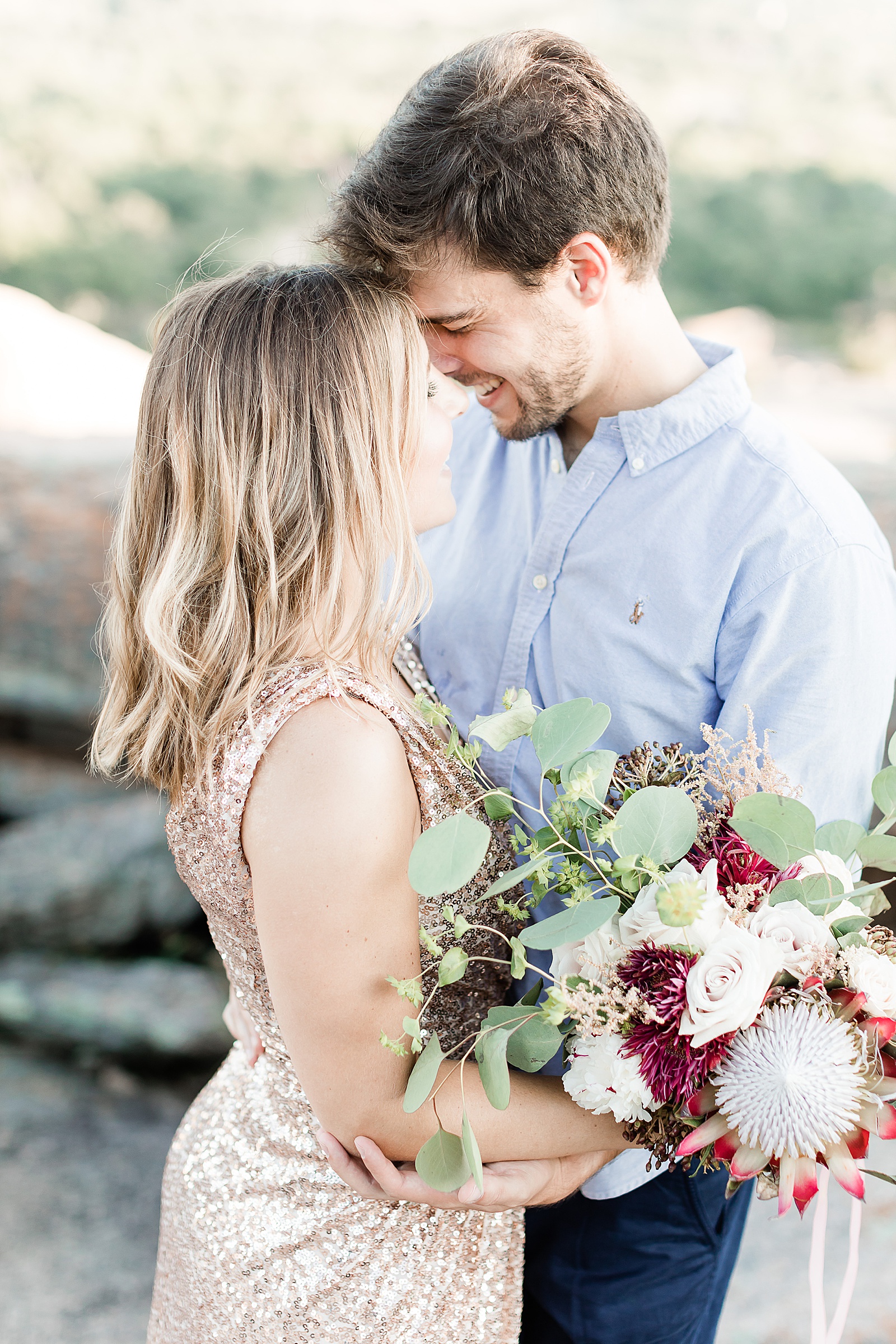 Couple kissing with wedding bouquet