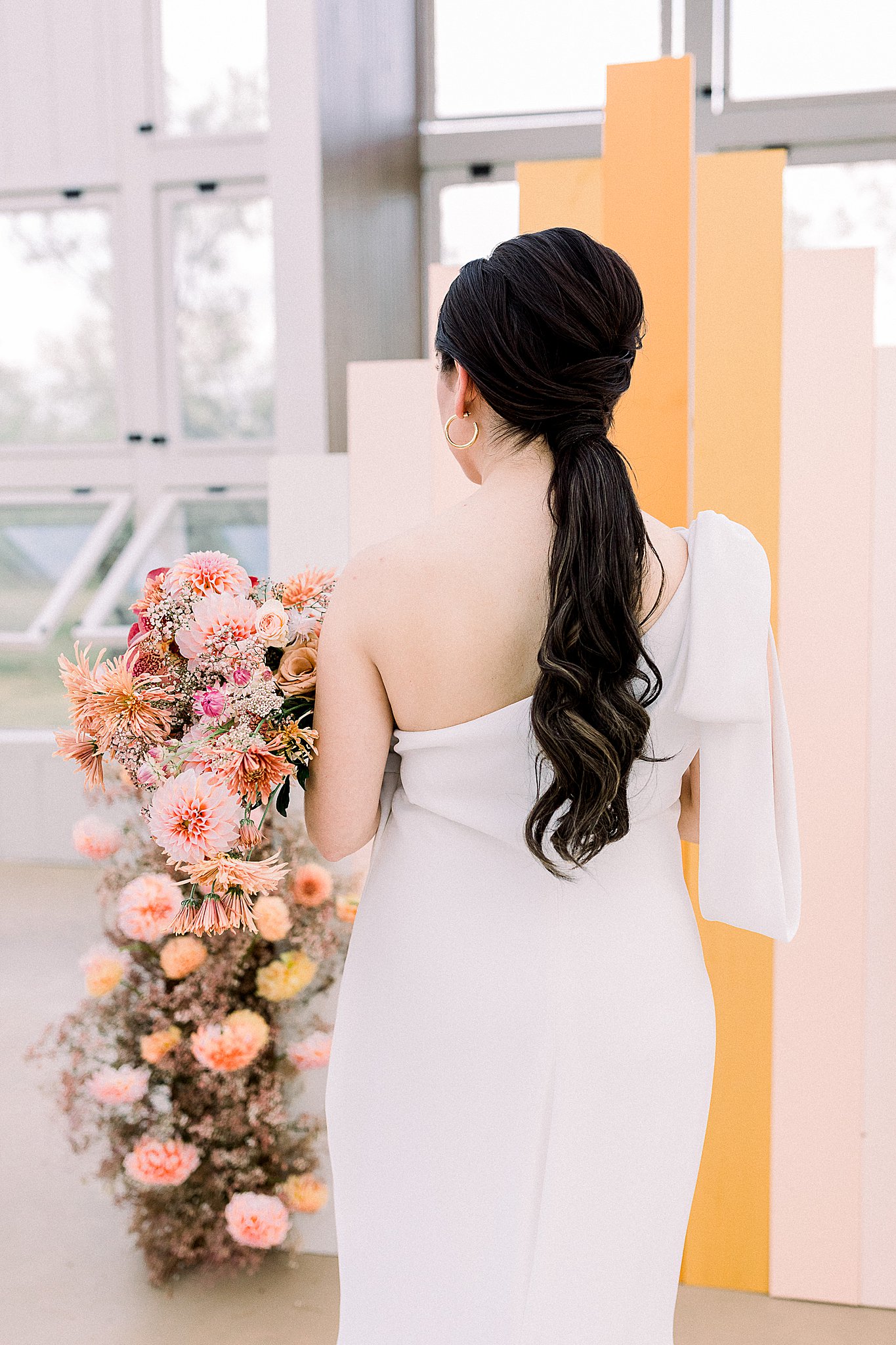 Bridal wedding gown back with peach florals, wedding hair inspiration