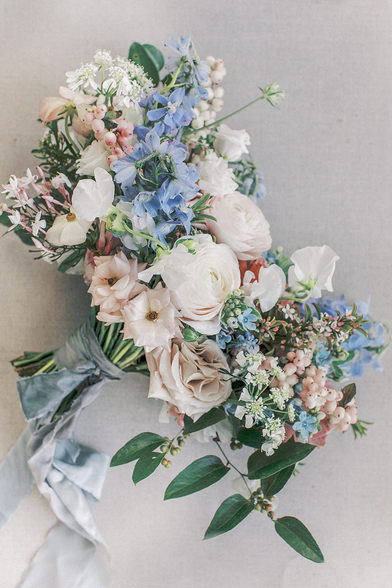 Light blue, blush pink, and white floral arrangement, bridal bouquet