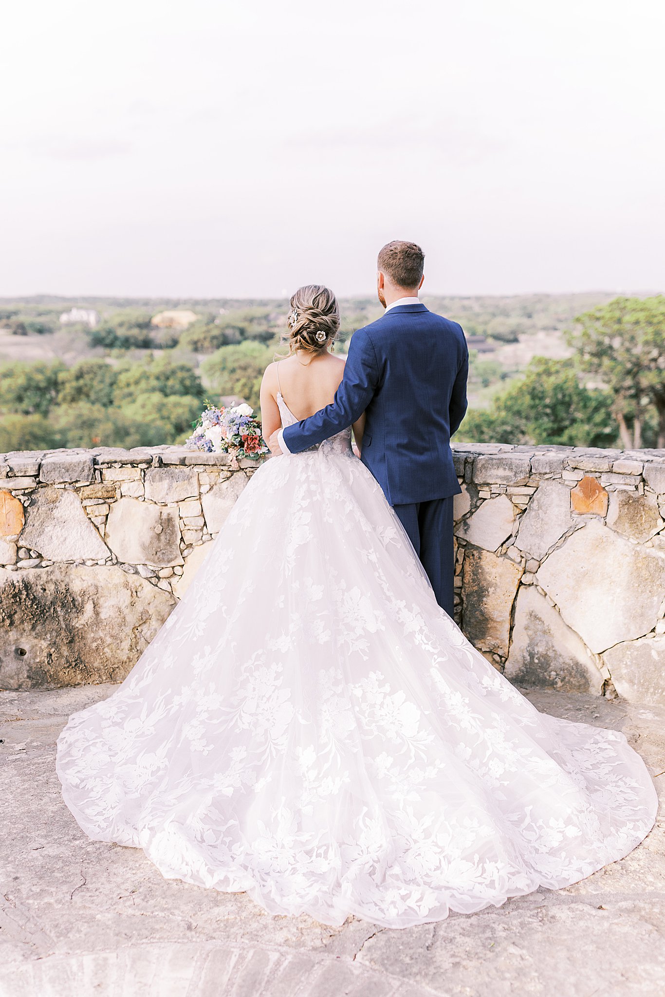bride and groom at Camp Lucy wedding venue, stone terrace view by Austin Wedding Photographer
