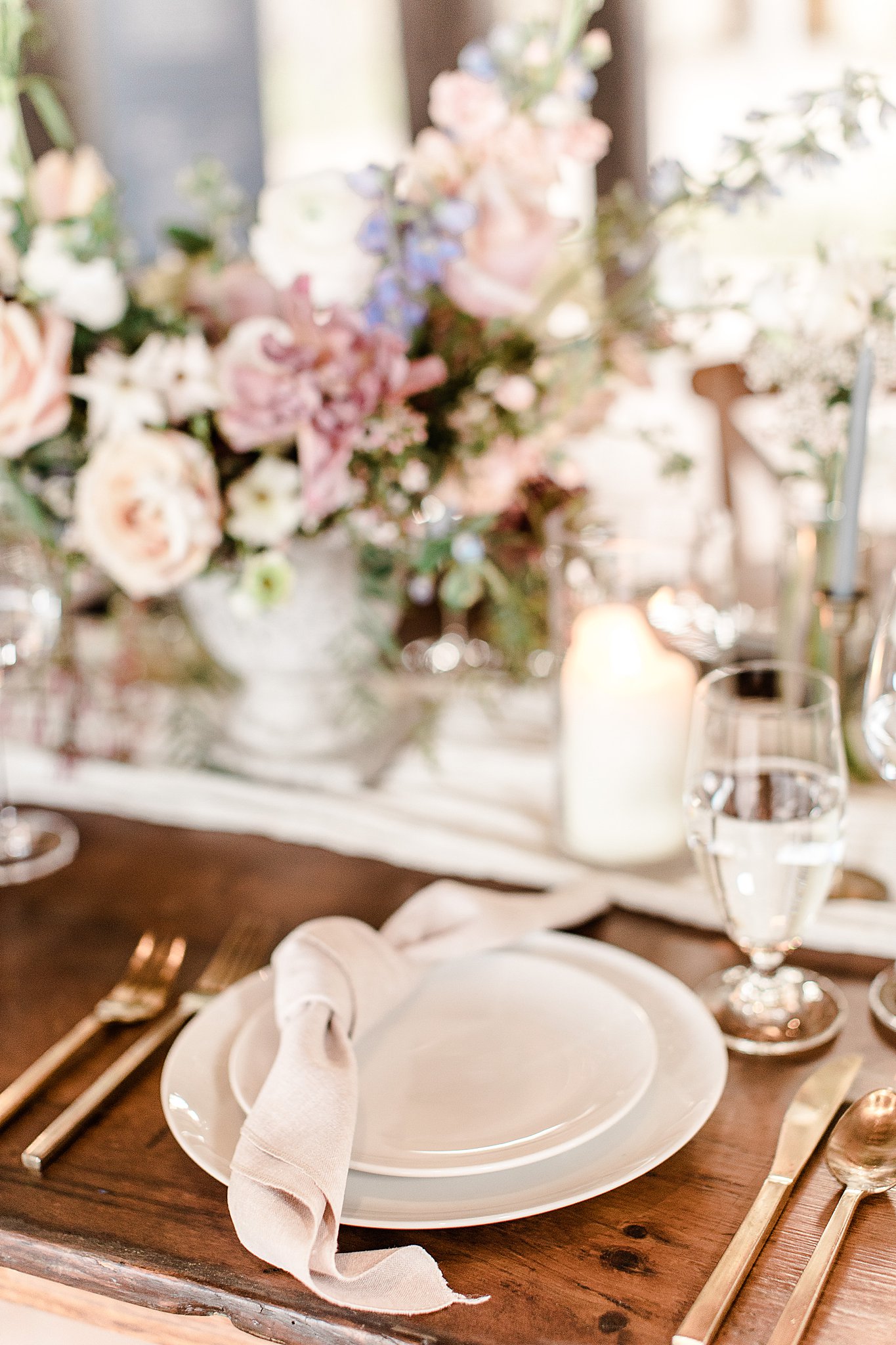 Wedding reception table details, gold and cream place setting, romantic table bouquet at Camp Lucy