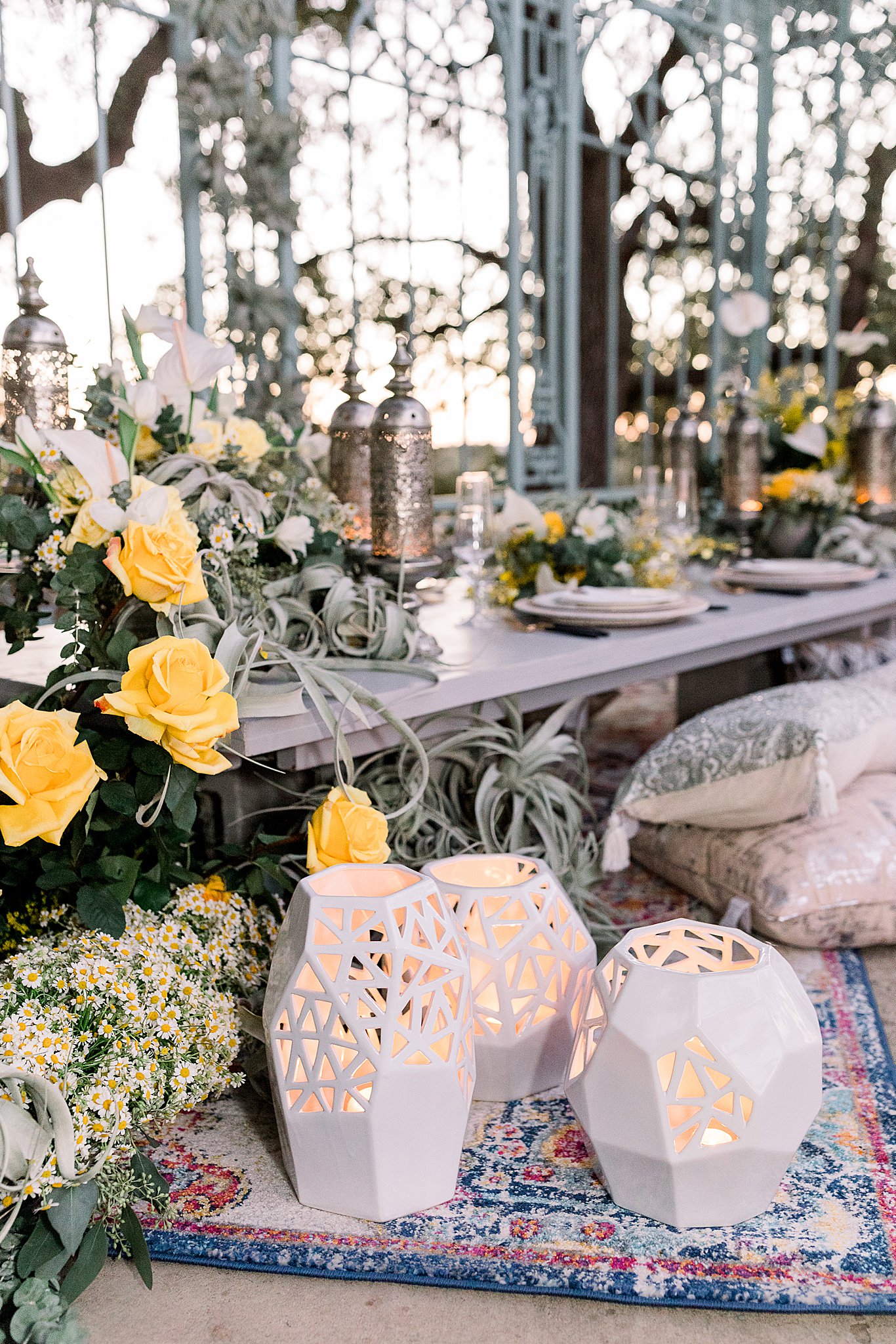 Lanterns, roses, and embroidered pillows with yellow roses Texas Indian Wedding at Ma Maison
